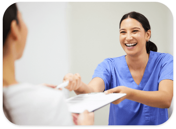 Dental team member reviewing paperwork with a patient