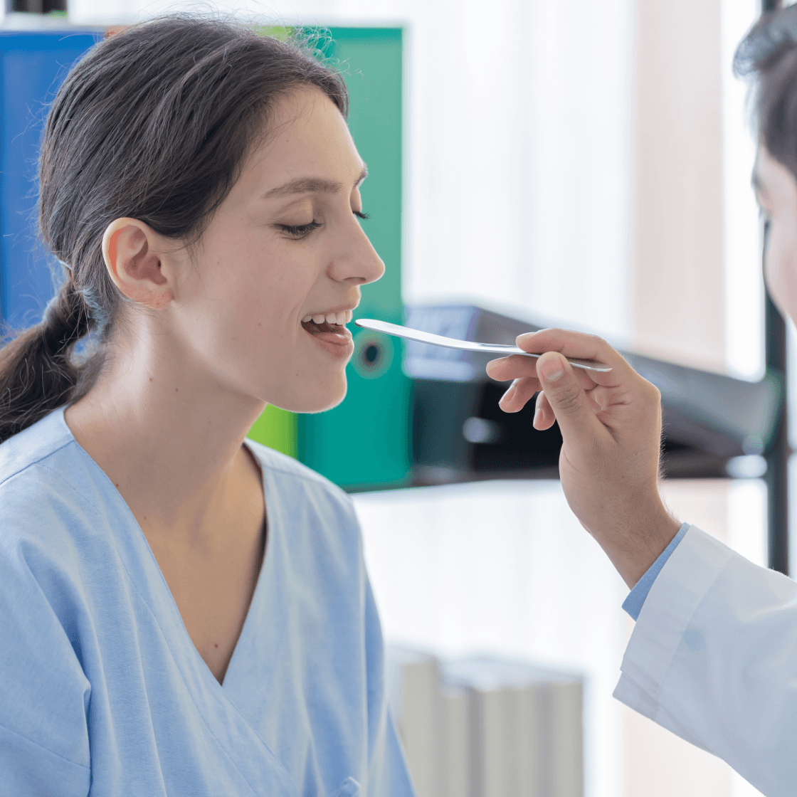 Patient opening her mouth for an oral cancer screening exam