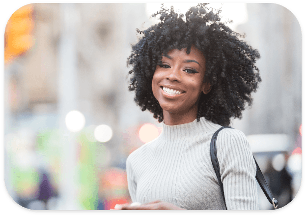 Woman smiling after teeth whitening treatment